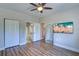 Bedroom with a closet, ensuite bath, hardwood floors, and TV at 2755 Via Capri # 1223, Clearwater, FL 33764