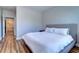 Neutral bedroom features wood floors, minimalist decor, and a gray headboard at 2755 Via Capri # 1223, Clearwater, FL 33764