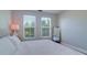 Bright bedroom features two windows with blinds, wood floors, and neutral décor at 2755 Via Capri # 1223, Clearwater, FL 33764