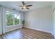Bedroom with hardwood floors and a large window overlooking a scenic canal at 2755 Via Capri # 1223, Clearwater, FL 33764