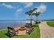 Scenic waterfront community fire pit with benches, palm trees and lovely views of the ocean at 2755 Via Capri # 1223, Clearwater, FL 33764