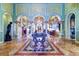 Grand foyer featuring marble floors, ornate columns, and a beautiful chandelier at 2755 Via Capri # 1223, Clearwater, FL 33764