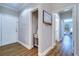 Bright hallway featuring wood floors, white trim, and an entryway table with decor at 2755 Via Capri # 1223, Clearwater, FL 33764