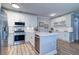 Modern kitchen equipped with stainless appliances, subway tile backsplash, and stylish white cabinetry at 2755 Via Capri # 1223, Clearwater, FL 33764
