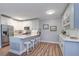 Bright and modern kitchen features white cabinets, stainless steel appliances, and a center island with bar stools at 2755 Via Capri # 1223, Clearwater, FL 33764