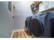 Laundry room featuring a washer, dryer, overhead cabinets, and clean finishes at 2755 Via Capri # 1223, Clearwater, FL 33764