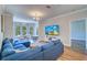 Inviting living room with a large sectional sofa, wood floors, and views of the dining area at 2755 Via Capri # 1223, Clearwater, FL 33764