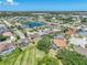 Attractive aerial view capturing a peaceful residential community with homes nestled around a serene lake, highlighting the tranquil setting at 2908 89Th E Ave, Parrish, FL 34219