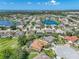 Scenic aerial shot displaying a charming neighborhood with multiple lakes and mature trees, emphasizing the community's natural beauty at 2908 89Th E Ave, Parrish, FL 34219