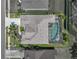 An aerial view of a screened-in pool, home with a dark roof, and a meticulously landscaped yard at 2908 89Th E Ave, Parrish, FL 34219