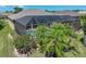 Aerial view of a screened-in pool with an adjoining patio area and lush green landscaping all around at 2908 89Th E Ave, Parrish, FL 34219