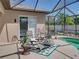 Relaxing backyard patio area with seating near the pool inside a screened-in enclosure for comfort and leisure at 2908 89Th E Ave, Parrish, FL 34219