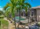 A screened-in pool and patio area surrounded by lush landscaping and rock ground covering for minimal maintenance at 2908 89Th E Ave, Parrish, FL 34219