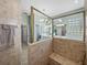 Tile shower area in the primary bath with a built-in seat and glass surround at 2908 89Th E Ave, Parrish, FL 34219