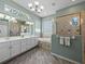 This bathroom features a double vanity, shower, and soaking tub with elegant tile accents at 2908 89Th E Ave, Parrish, FL 34219