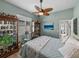 Inviting bedroom showcases a ceiling fan, shuttered window, and charming display cabinets at 2908 89Th E Ave, Parrish, FL 34219