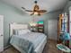 Comfortable bedroom with decorative ceiling fan and beach-themed decor, creating a cozy and inviting space at 2908 89Th E Ave, Parrish, FL 34219