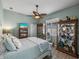 Relaxing bedroom with a ceiling fan, shuttered windows, and built-in display cabinets at 2908 89Th E Ave, Parrish, FL 34219