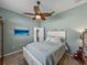 Serene bedroom featuring a ceiling fan and calming coastal decor and light blue walls at 2908 89Th E Ave, Parrish, FL 34219