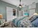 Relaxing bedroom featuring a seashell themed bedspread, outdoor access, and a view of the lanai at 2908 89Th E Ave, Parrish, FL 34219