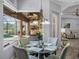 Bright breakfast nook with view of the screened lanai, outdoor kitchen, and pool at 2908 89Th E Ave, Parrish, FL 34219
