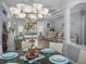 Open dining area with view to the pool, featuring modern chandelier and seating for six guests at 2908 89Th E Ave, Parrish, FL 34219