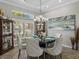 Formal dining room with a chandelier, large windows, and elegant decor for sophisticated dining at 2908 89Th E Ave, Parrish, FL 34219