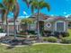 Charming home with well-manicured lawn, tropical landscaping, and attractive exterior details under a bright sky at 2908 89Th E Ave, Parrish, FL 34219