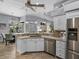 Bright kitchen with stainless steel appliances, granite counters, and a breakfast bar overlooking the dining area at 2908 89Th E Ave, Parrish, FL 34219