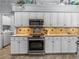 Modern kitchen featuring granite countertops, stainless steel appliances, and tile backsplash at 2908 89Th E Ave, Parrish, FL 34219