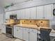 Kitchen showcasing white cabinets, granite countertops, and stainless steel appliances at 2908 89Th E Ave, Parrish, FL 34219