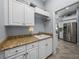 Laundry room featuring granite countertops and white cabinets at 2908 89Th E Ave, Parrish, FL 34219
