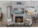 Comfortable living room featuring a fireplace, two chairs, and view to kitchen at 2908 89Th E Ave, Parrish, FL 34219
