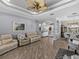 Spacious living room with couches, entryway, and view to the dining area and front door at 2908 89Th E Ave, Parrish, FL 34219