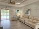 Cozy living room with access to the pool and neutral-toned furniture, offering a relaxing atmosphere at 2908 89Th E Ave, Parrish, FL 34219