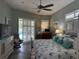 Inviting main bedroom with ensuite bath, hardwood floors, and lanai access at 2908 89Th E Ave, Parrish, FL 34219