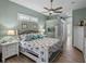 Inviting main bedroom with ensuite bath, hardwood floors, and ensuite bath access at 2908 89Th E Ave, Parrish, FL 34219