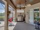 Covered patio boasts an outdoor grill, fan, dining area, and easy access to a gorgeous pool at 2908 89Th E Ave, Parrish, FL 34219