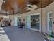 Open patio with a beautiful wood ceiling, fan, grill, and a doorway to the living area at 2908 89Th E Ave, Parrish, FL 34219