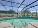 Relaxing screened-in pool area with lush landscaping, water feature, and plenty of lounging space at 2908 89Th E Ave, Parrish, FL 34219