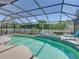 Enjoy a beautiful screened-in pool area with lush landscaping and lots of room to relax at 2908 89Th E Ave, Parrish, FL 34219