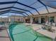 Inviting screened-in pool with a fountain, comfortable lounge chairs, and outdoor cooking area at 2908 89Th E Ave, Parrish, FL 34219