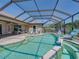 Sparkling pool with screen enclosure, dolphin statues, and ample seating for relaxation at 2908 89Th E Ave, Parrish, FL 34219