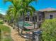 Inviting pool area with an enclosed lanai, palm trees, and well-maintained landscaping at 2908 89Th E Ave, Parrish, FL 34219