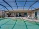 Beautiful screened-in pool area with multiple seating areas, barbecue, and easy access to the home's interior at 2908 89Th E Ave, Parrish, FL 34219
