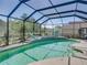 Serene screened-in pool featuring a dolphin fountain, lush landscaping, and comfortable lounge chairs at 2908 89Th E Ave, Parrish, FL 34219