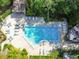 Aerial view of a community pool with chairs and tables at 2953 Yucca Ct, Palm Harbor, FL 34684