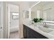 Bright bathroom featuring a dual sink vanity with modern fixtures and access to the shower and toilet room at 2953 Yucca Ct, Palm Harbor, FL 34684