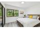 Bedroom featuring a large window providing natural light and views of the surrounding landscape at 2953 Yucca Ct, Palm Harbor, FL 34684