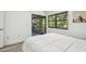 Bright bedroom with a neutral color scheme and access to a screened lanai at 2953 Yucca Ct, Palm Harbor, FL 34684
